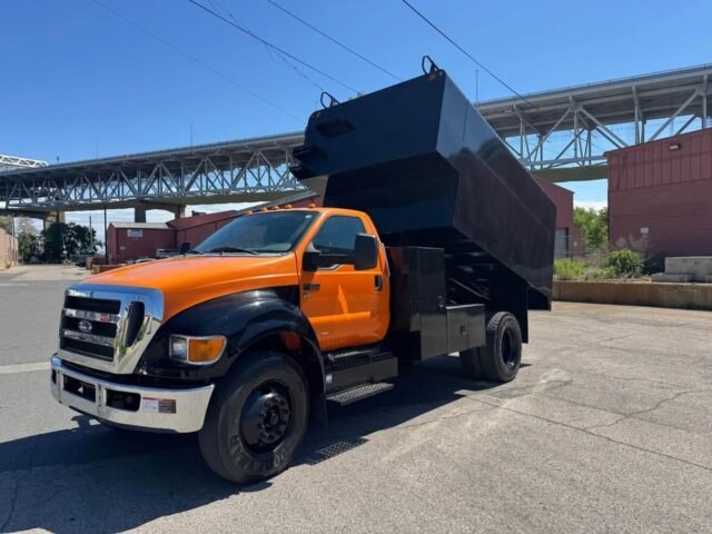 2014 Ford F-650 Chipper Dump Truck, front three-quarter view with dump body raised