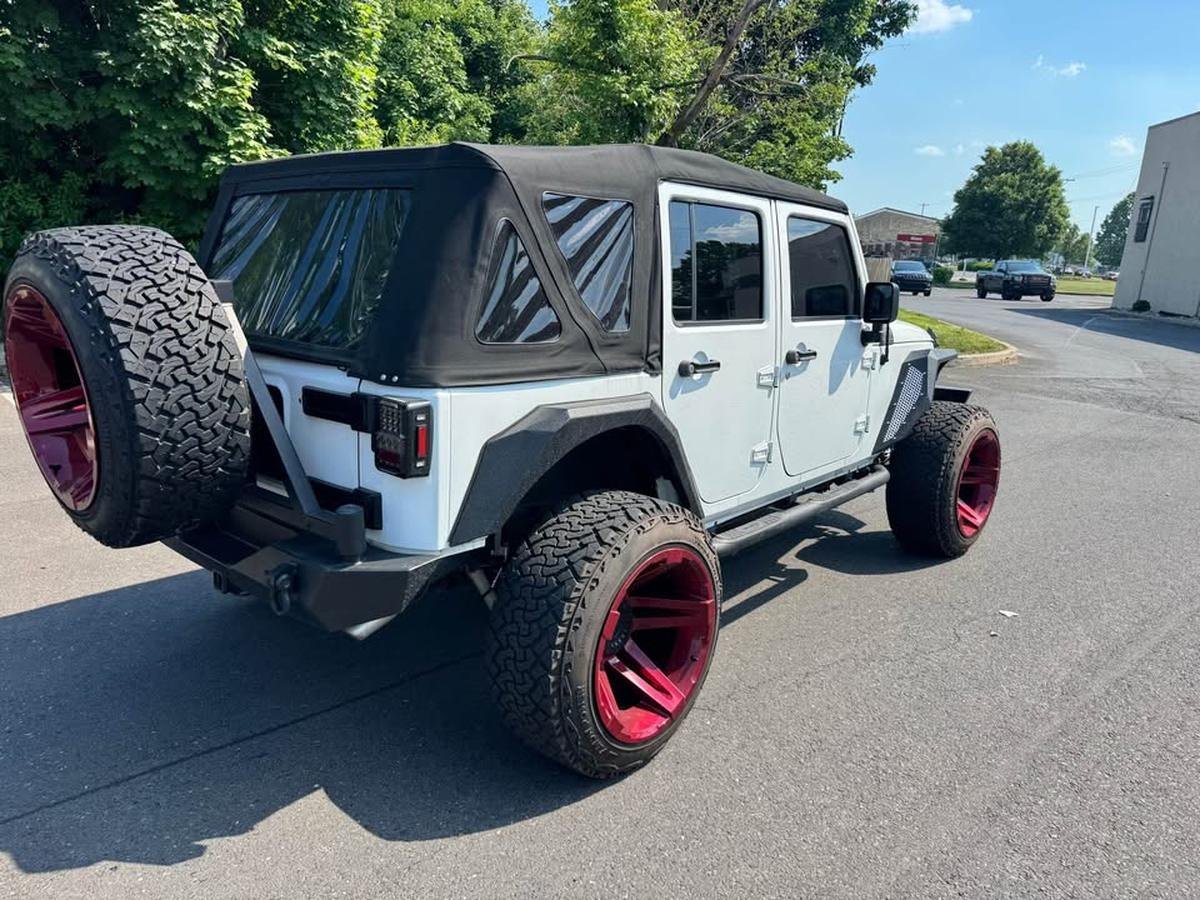 2017 Jeep Wrangler Unlimited Sport, rear three-quarter view
